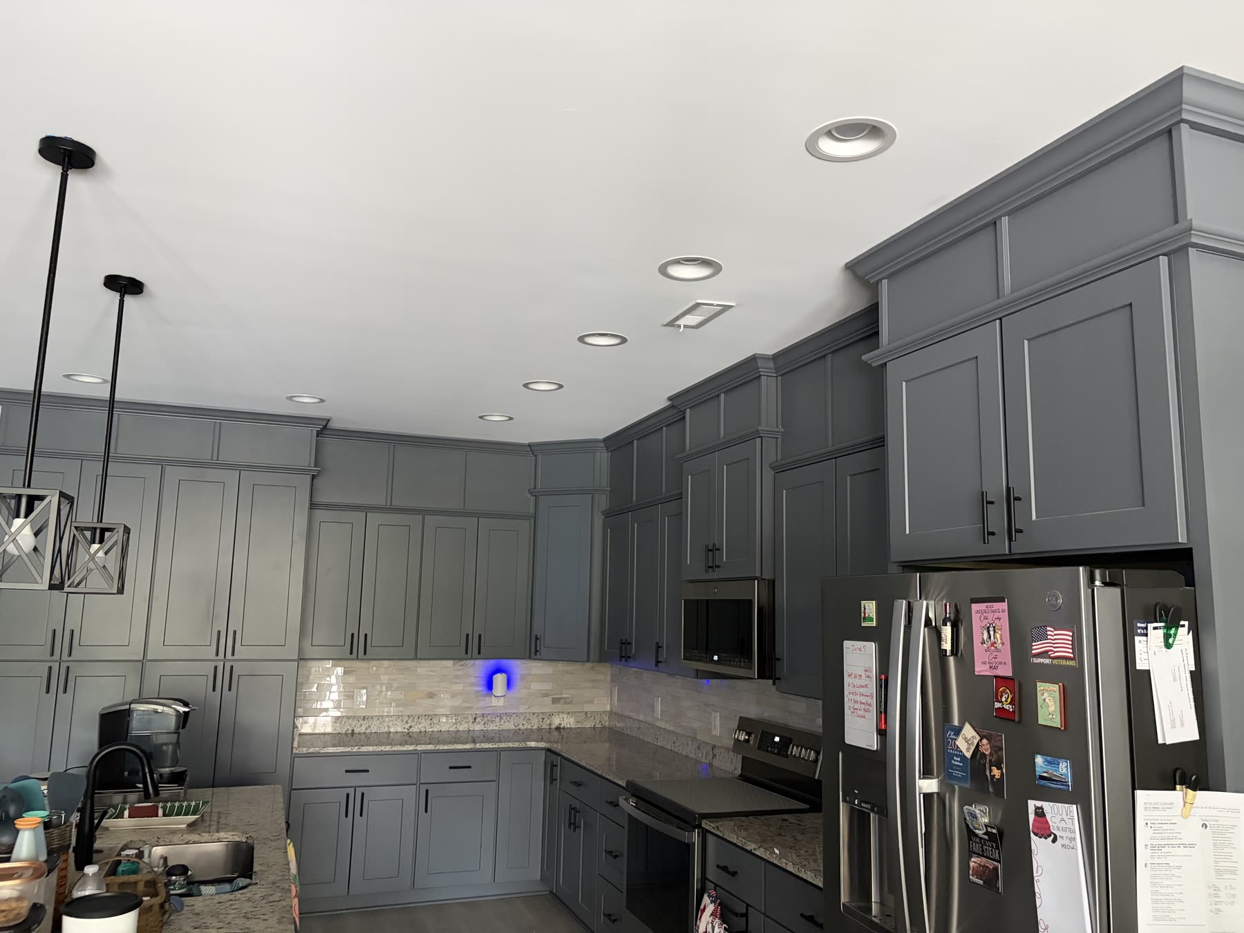 Charcoal shaker kitchen with granite counters, crown molding, and stainless appliances